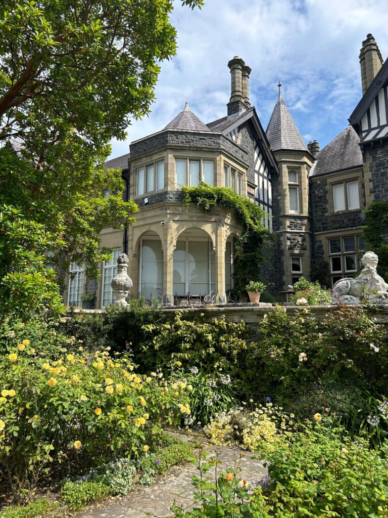 Bodnant gardens view of the house with roses in foreground